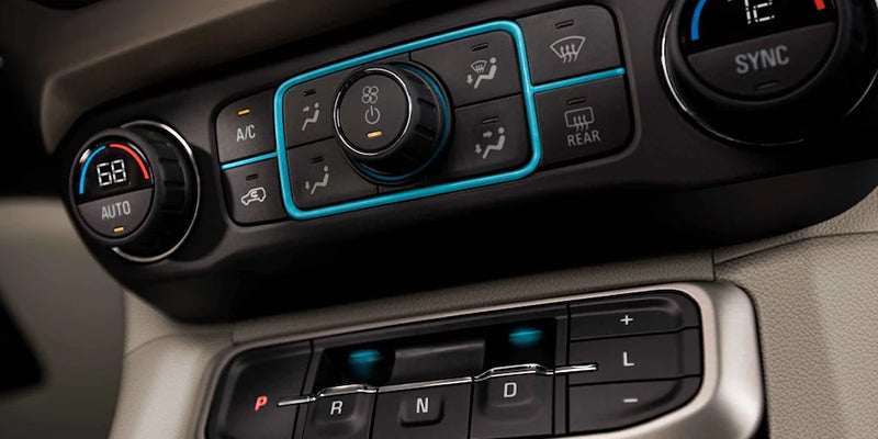 Close-up of 2023 GMC Acadia climate controls and gear shifter.