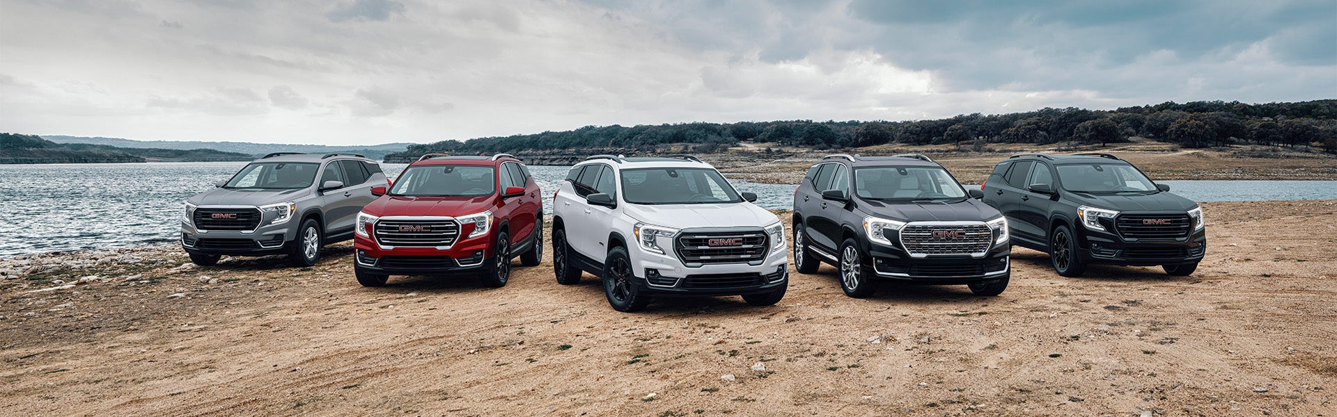 Lineup of 2023 GMC Terrain SUVs in different colors.
