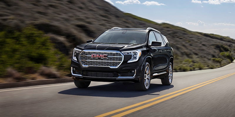 2024 GMC Terrain driving on an open road.