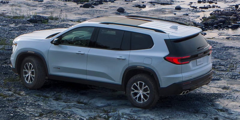 White GMC Acadia side.
